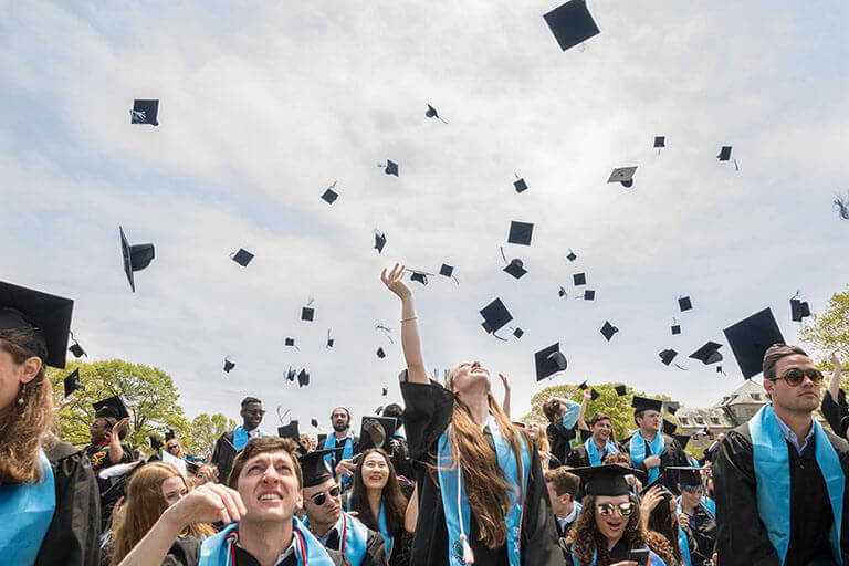students throwing caps at graduation